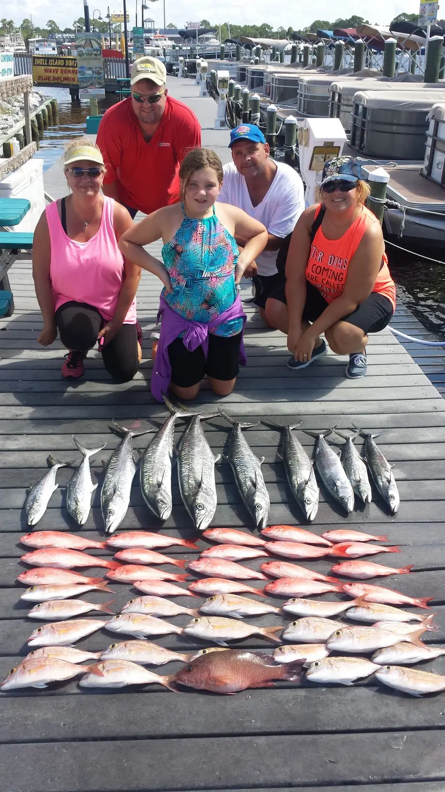 A fishing party with king mackerel and red snapper on the dock in Panama City