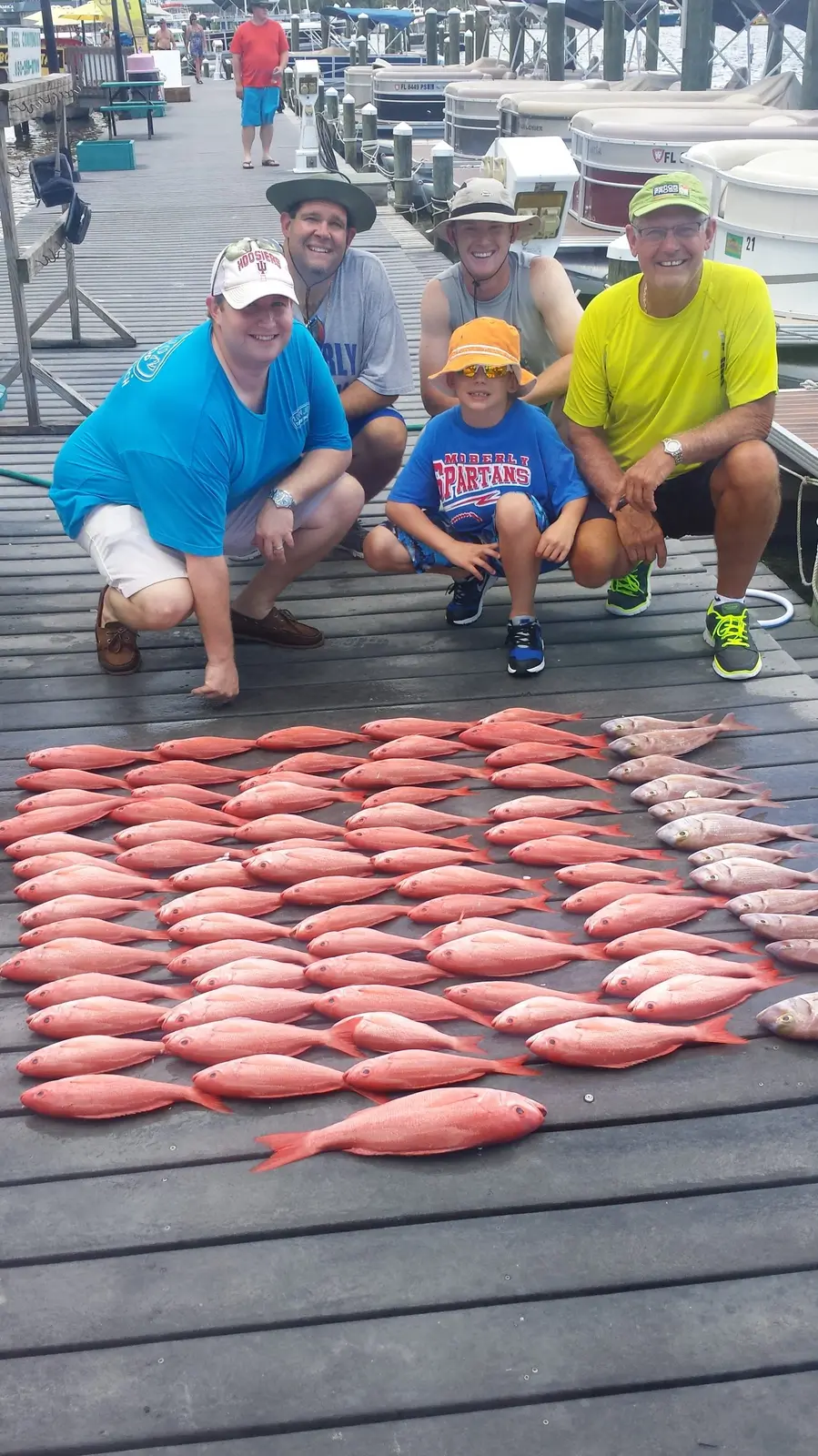 A family fishing charter group with a big catch of red snapper